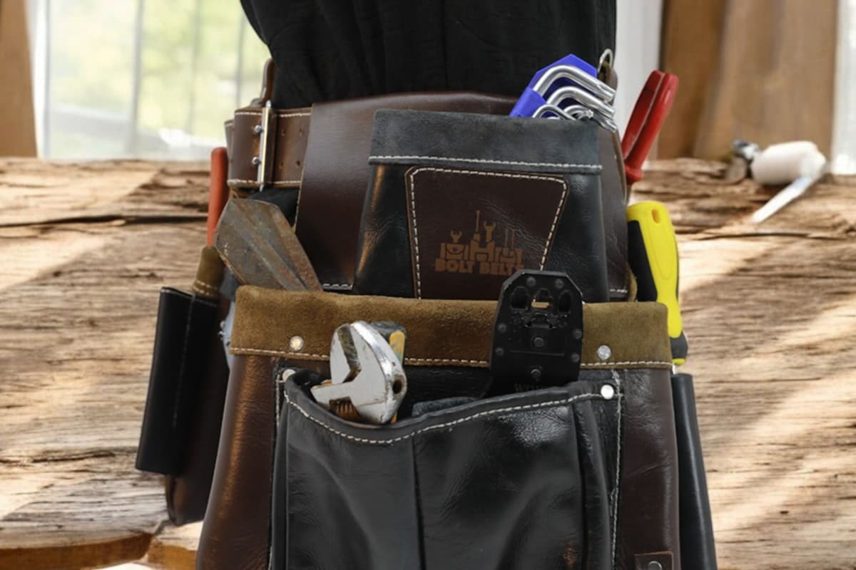 Tool belt filled with professional hand tools for maintenance