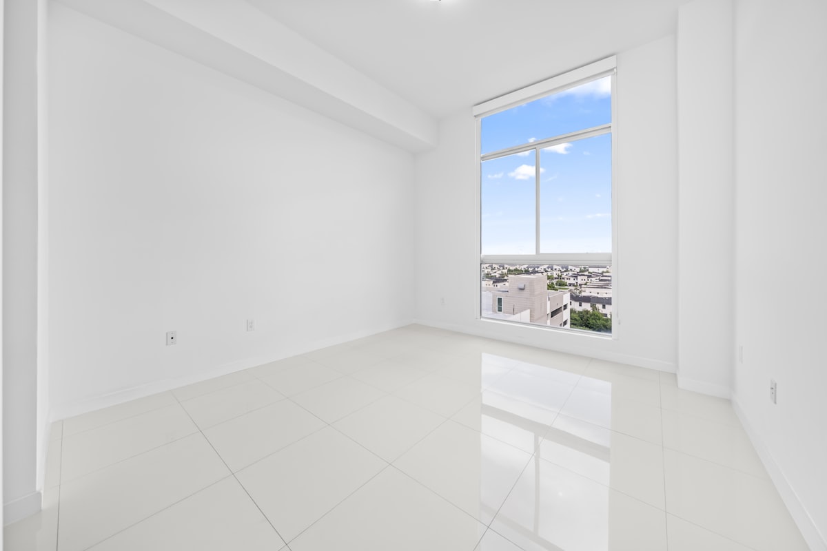 Bright empty room with large windows ready for new tenants